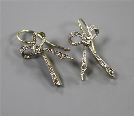 A pair of 20th century yellow metal and diamond set ribbon bow drop earrings, bow 22mm, gross weight 3.8 grams.